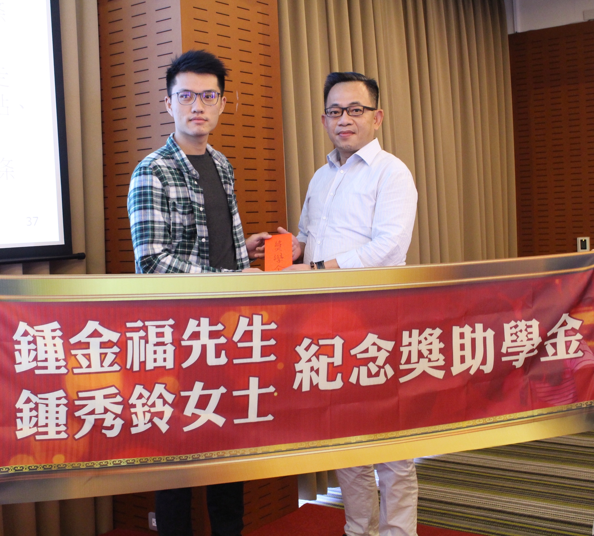 鍾志雄學長(右)頒贈獎學金給謝全洲同學(左)圖片